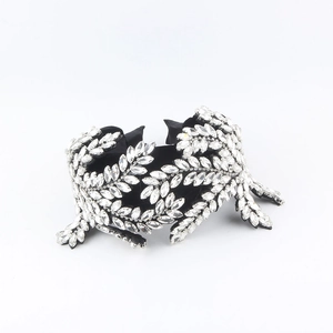 Macro detail of luxury velvet headband with sparkling marquise rhinestones in leaf pattern