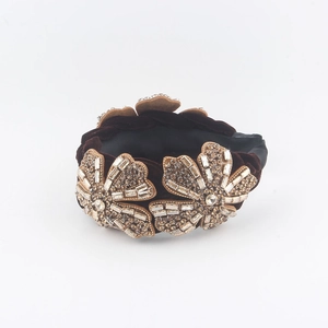 Detail of luxury brown velvet headband with three sparkling crystal rhinestone flowers