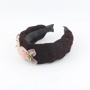 Detail of velvet braided headband featuring pink sequin and organza flower applique