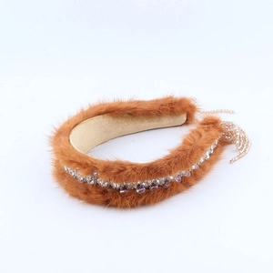Detail of luxury brown mink fur headband with sparkling rhinestones and beaded tassels