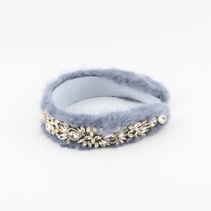 Detail of grey plush headband with intricate rhinestone flower crystals on soft faux fur