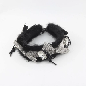 Macro shot of faux mink headband with rhinestone bows and beaded fringes detail