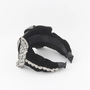 Detail view of luxury black velvet headband featuring elaborate rhinestone embellishments