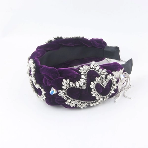 Detail of purple velvet braided headband with heart crystal frames and butterfly tassels