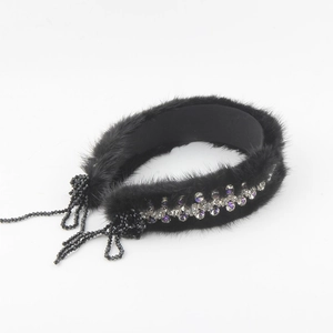 Detail of luxury mink fur headband with sparkling rhinestones and black tassel charms