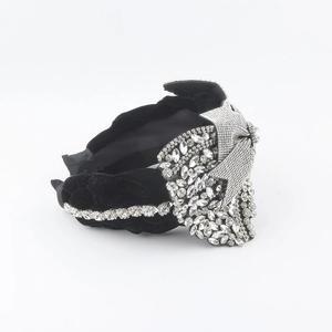 Detail of black velvet headband featuring intricate silver rhinestone star patterns