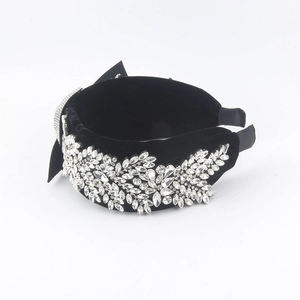 Detailed macro view of black velvet headband with luxury crystal flower patterns