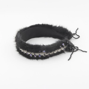 Detailed macro shot of the black faux fur headband with sparkling row of rhinestones