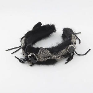 Detailed shot of mink fur headband with rhinestone bow and dangling crystal beads