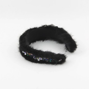 Nahaufnahme des schwarzen Pelz-Haarreifs mit weißen Perlen und bunten Glitzersteinen
