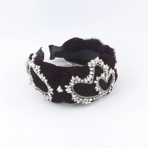 Detail of burgundy velvet headband showing heart crystal rhinestones and texture