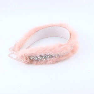 Close-up detail of luxury pink faux fur headband with silver rhinestones and beads