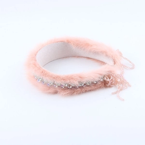 Detailed macro view of luxury pink mink fur headband featuring crystal tassels and rhinestones