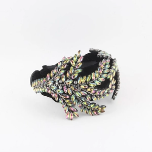 Detail of baroque velvet headband featuring colorful marquise rhinestones in leaf patterns
