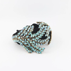 Detail of baroque black velvet headband with light blue marquise crystal leaf patterns
