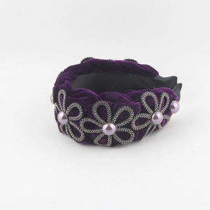 Detail of purple velvet headband featuring crystal floral patterns and imitation pearls
