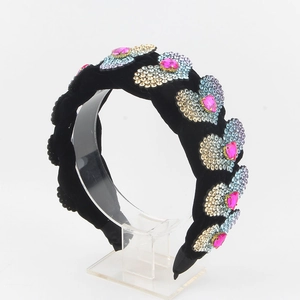 Detail of velvet padded headband with pink heart gemstone and colorful crystals