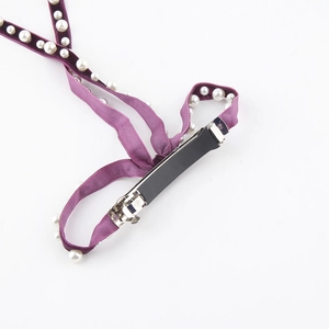 Elegant purple velvet bow hair clip with white pearls featuring a sturdy black metal clasp