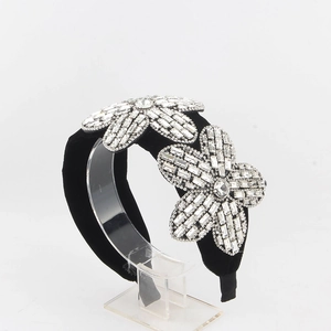 Detail of baroque black velvet sponge headband with large rhinestone floral embellishments