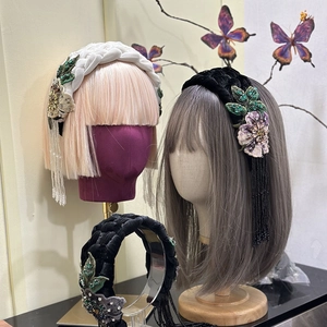 Detail of wide velvet braided headband featuring crystal tassels and floral embroidery