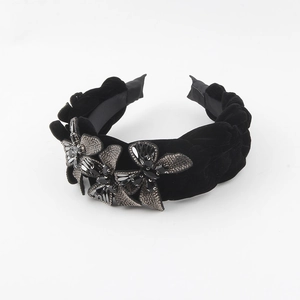 Macro shot of black velvet braided headband with three crystal-embellished butterfly charms