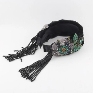 Velvet braided headband with floral embroidery and hanging black beaded tassels