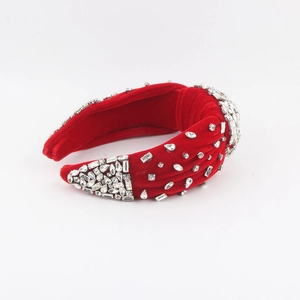Close-up of red velvet headband featuring hand-stitched crystal rhinestones and central knot