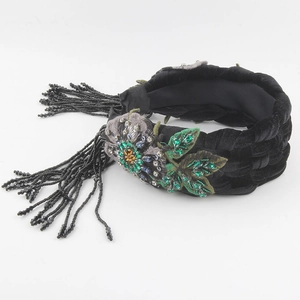 Detail of velvet braided headband with crystal flowers and hanging black bead tassels
