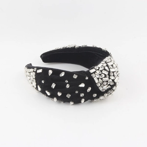 Close-up of black velvet headband featuring hand-sewn sparkling crystal rhinestones