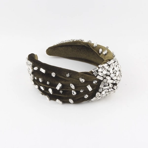 Close-up of olive green velvet headband with hand-stitched crystal rhinestones