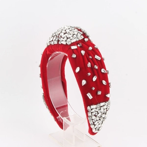 Close-up of red velvet headband with hand-stitched crystal rhinestones and knotted design
