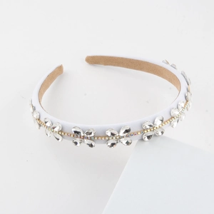Baroque crystal flower headband with white fabric lining and shiny rhinestone details