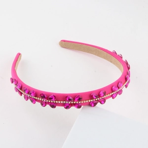 Detail of fuchsia rhinestone floral headband with velvet texture and non-slip inner lining