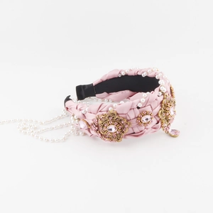 Vintage pink braided headband with baroque rhinestones and pearl tassels on white background
