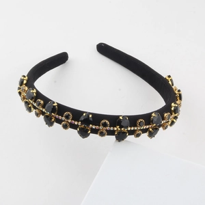 Detail of baroque headband with black crystals and gold metal claw settings