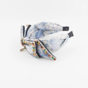 Luxury light blue floral fabric headband with a large rhinestone bow and pearls