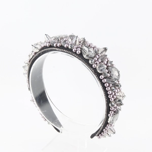 Close-up of luxury velvet headband with sparkling crystals and lavender faux pearls