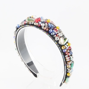 Detailed view of colorful rhinestones and crystals on a wide beaded baroque headband
