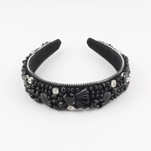 Detailed view of black velvet headband with luxury rhinestones and beaded craftsmanship