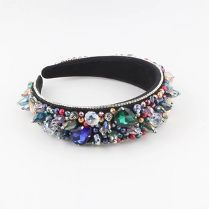 Macro shot of colorful rhinestones and crystal beads on a black wide luxury headband