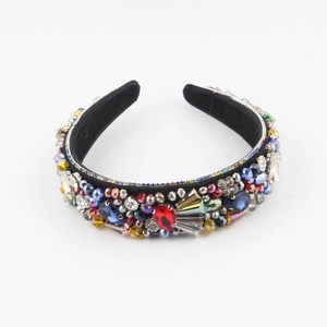 Detailed macro view of colorful rhinestones and crystals on black velvet padded headband