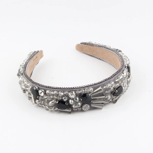 Detail of baroque velvet headband with rhinestones, black gems and silver metal accents