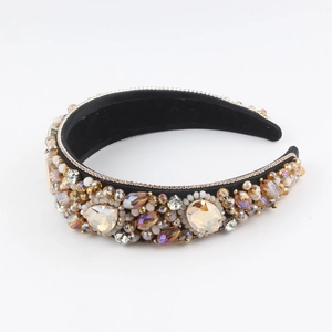 Close-up of luxury Baroque headband with champagne crystals and beads on black velvet