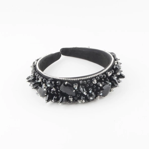 Detailed close-up of handmade padded headband with black crystals and silver floral accents