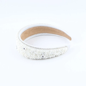 Detail of white padded headband with faux pearls, rhinestones and anti-slip lining