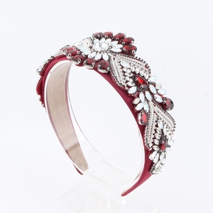 Close-up of luxury Baroque headband with red crystals and silver floral beadwork