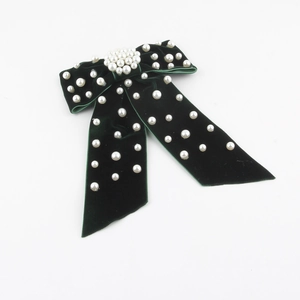Dark green velvet bow hair clip with luxury pearl embellishments on a long tail design