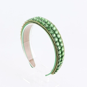 Detailed macro view of the green rhinestone baroque headband with golden beaded edging