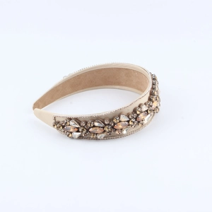 Detail of handmade padded headband with champagne crystals and velvet anti-slip lining