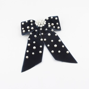 Elegant navy velvet bow hair clip with faux pearl embellishments on a clean white background